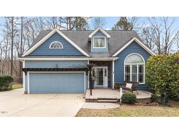 Charming blue two-story home with a neatly kept lawn and inviting front porch at 1217 Hillingdon Way, Raleigh, NC 27614