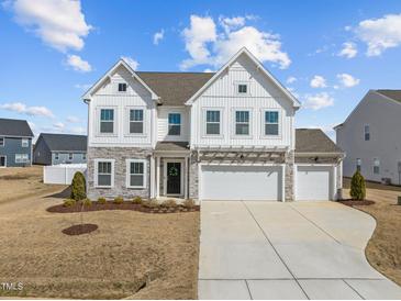 Beautiful two-story home with stone accents and a three-car garage at 350 Arlie Ln, Lillington, NC 27546