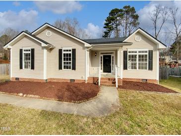 Charming single-story home featuring a well-manicured lawn and inviting entrance at 4023 Cashew Dr, Raleigh, NC 27616