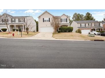 Traditional two-story home featuring a two-car garage and well-maintained front yard in a quiet neighborhood at 4201 Hampstead Village Dr, Durham, NC 27703