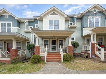 Inviting townhome exterior with charming front porch, brick accents, and well-maintained landscaping at 521 Eastway Ave # Apt B, Durham, NC 27703
