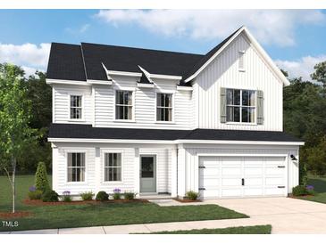 Charming two-story home with white siding, black roof, manicured lawn, and an attached two-car garage at 700 Compeer Way # 29, Rolesville, NC 27571
