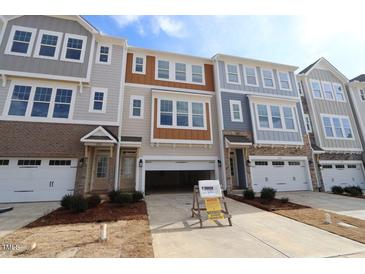 New construction townhome featuring multiple stories, attached garages, and landscaped front yards at 2323 Bay Minette Sta # 547, Apex, NC 27502