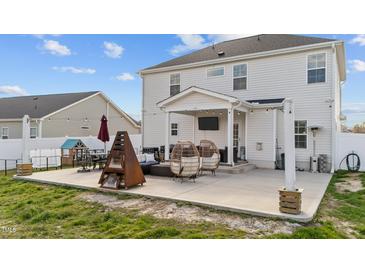 Relaxing back patio featuring a covered porch, fire pit, comfortable seating and outdoor tv at 277 Martins Mill Ct, Wendell, NC 27591