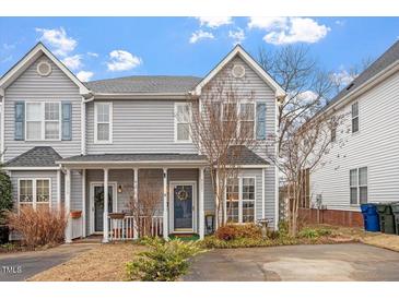 Charming two-story townhome with well-maintained landscaping and a welcoming front porch at 5321 Cog Hill Ct, Raleigh, NC 27604