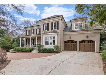 Beautiful brick home featuring a two-car garage and covered front porch at 705 Glen Eden Dr, Raleigh, NC 27612