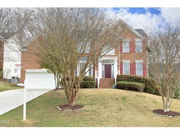 Charming brick two-story home with attached garage and well-maintained lawn at 122 Banyon Tree Ln, Cary, NC 27513