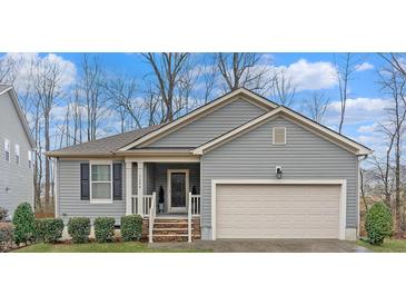 Charming single-story home with a two-car garage and landscaped front yard at 1600 Frog Hollow Way, Wake Forest, NC 27587