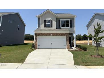Charming two-story home featuring a two-car garage and well-manicured lawn at 192 Bruce Dr, Dunn, NC 28334