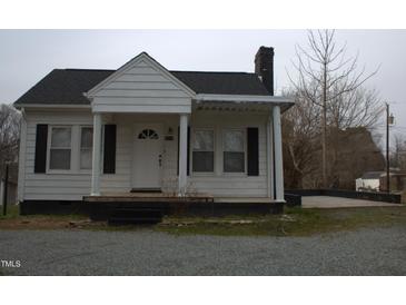 Charming one story home featuring black shutters, front porch and a quaint design at 2110 Carolina Mill Rd, Burlington, NC 27217