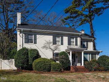 Beautiful white brick two-story home with black shutters and well-manicured landscaping at 2521 St Mary'S St, Raleigh, NC 27609