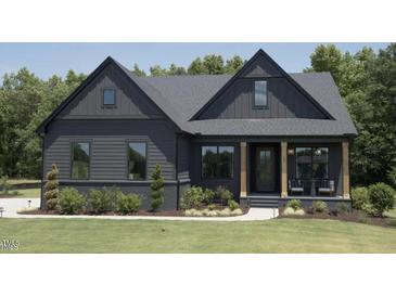 Charming two-story home featuring a manicured lawn and inviting front porch at 33 Henry Ct, Chapel Hill, NC 27516
