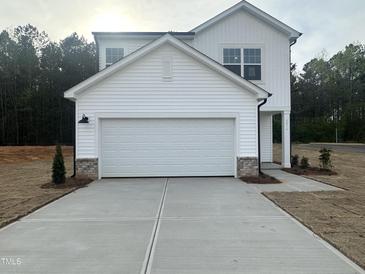 New two story home with a white exterior, concrete driveway, and attached two car garage at 6814 Galloway Dr, Middlesex, NC 27557