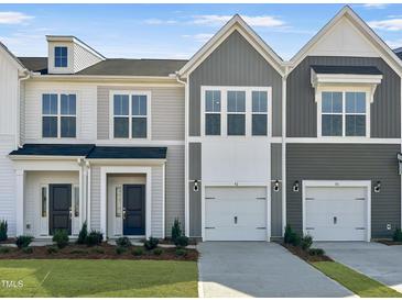 Charming townhome exteriors with two-car garages, neat lawns and beautiful landscaping at 92 Ripple Way # 315, Clayton, NC 27520