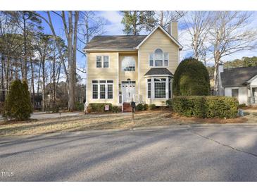 Charming two-story yellow home with well-manicured landscaping at 1 Nicklaus Way, Clayton, NC 27520