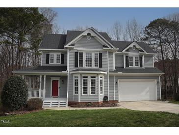 Charming two-story home featuring gray siding, black shutters, and a well-manicured lawn at 113 Hawkscrest Ct, Apex, NC 27502