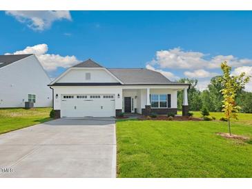 Charming single-story home with a two-car garage and well-manicured lawn at 1794 Parham Dr, Graham, NC 27253