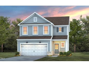 Charming two-story home with gray siding, white trim, a two-car garage, and a manicured lawn at 521 Providence Springs Ln, Fuquay Varina, NC 27526