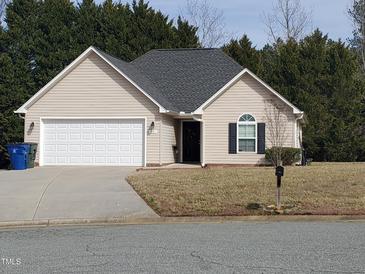 Charming single-story home with attached garage, well-maintained lawn, and traditional architectural details at 631 Natalie Dr, Graham, NC 27253