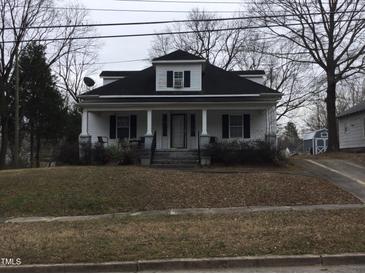 Charming home featuring a covered front porch and inviting curb appeal, perfect for relaxing outdoors at 925 Harris St, Burlington, NC 27217