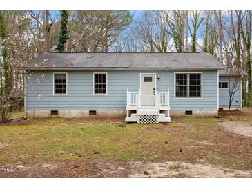 Charming single-story home featuring a light blue exterior and a welcoming white front porch at 136 Dixie Ln, Youngsville, NC 27596