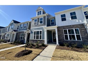 Charming townhome with stone accents, well-manicured lawn, and welcoming entrance at 2353 Whitewing Ln, Wendell, NC 27591