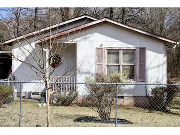 Charming home featuring a cozy front porch and a fenced yard, offering a blend of comfort and security at 309 Cody St, Durham, NC 27703