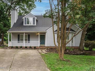 Charming single-Gathering home with a covered porch, dormer windows, and mature trees at 102 Ventura Woods Ct, Wake Forest, NC 27587