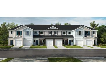 Charming townhome exteriors featuring light color palettes, attached garages and well-manicured lawns at 10526 Brookside Reserve St, Raleigh, NC 27614