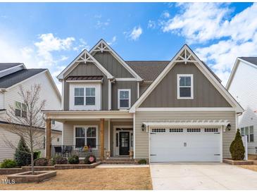 Charming two-story home featuring a welcoming front porch and a two-car garage at 1530 Armscroft Ln, Apex, NC 27502