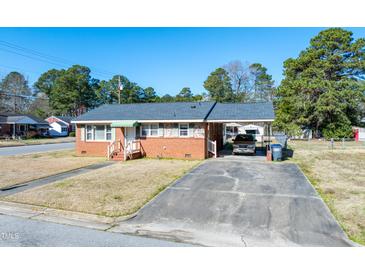Charming brick home featuring a covered carport and well-maintained front yard at 2608 Walley St, Rocky Mount, NC 27803