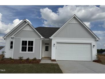 Charming single-Gathering home featuring a spacious two-car garage and a well-manicured front yard at 338 Tormore Dr, Homesite 123, Sanford, NC 27330