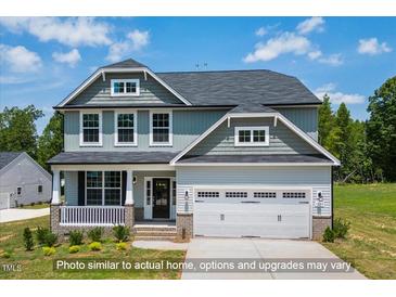 Charming two-story home with a covered front porch and an attached two-car garage at 5372 Salem Woods Dr # 18, Graham, NC 27253