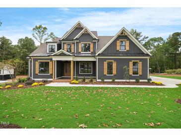 Charming two-story home featuring a beautifully landscaped yard and a welcoming covered porch at 1600 Sweetwater Ln, Raleigh, NC 27610