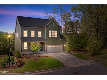 Charming two-story home featuring an attached two-car garage and beautifully landscaped front yard at 1680 Mint River Dr, Apex, NC 27502