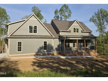 Charming craftsman-style home with board and batten siding, and a welcoming covered front porch at 2833 Faucette Ln, Burlington, NC 27217