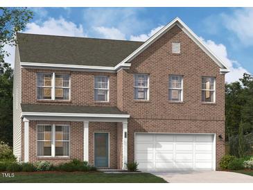 Charming two-story brick home with an attached garage and a covered front porch, offering classic curb appeal at 3205 Shannon Woods Lane # 20, Apex, NC 27523