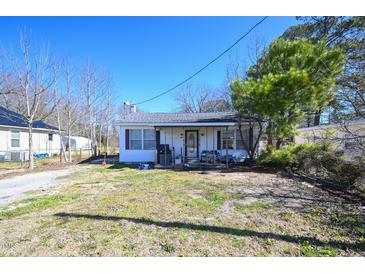 Charming single-story home with a cozy front porch and a well-manicured front yard at 407 Iris Bryant Rd, Dunn, NC 28334