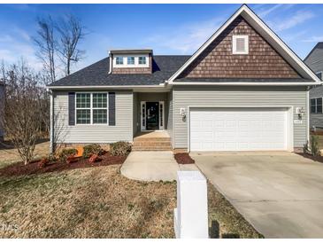 Charming single-story home featuring a two-car garage, landscaped yard, and traditional architectural details at 480 Stonewall Dr, Mebane, NC 27302