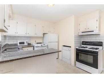 Charming kitchen featuring white appliances, bright cabinetry, and a granite countertop bar at 529 Hillsborough # H-6, Chapel Hill, NC 27514