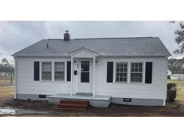 Charming one-story home with a white exterior, black shutters, and a well-maintained front yard at 804 S Sampson Ave, Dunn, NC 28334