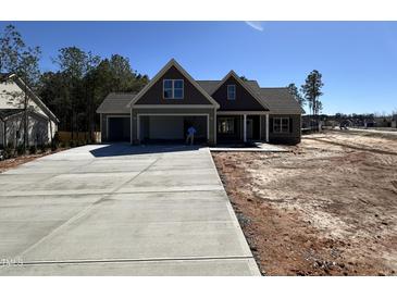 New construction home with a spacious driveway and a charming craftsman-style facade at 100 Spumante Ct, Princeton, NC 27569