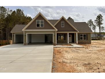 Inviting two-story home with a three-car garage and stone accents in a well-developed community at 100 Spumante Ct, Princeton, NC 27569