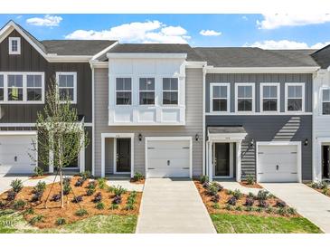 Charming townhomes with attached garages, professionally landscaped yards, and neutral color schemes at 116 Central Townes Way # 293, Raleigh, NC 27603