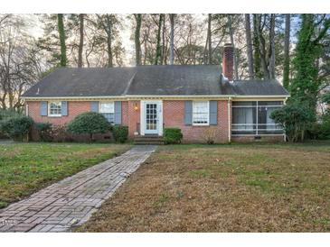Charming single-story brick home with a brick walkway, inviting curb appeal, and mature trees at 127 Wilkinson St, Rocky Mount, NC 27804