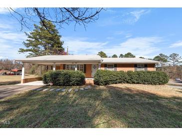 Charming brick home with a covered carport and well-maintained landscaping at 2311 Glover Rd, Durham, NC 27703