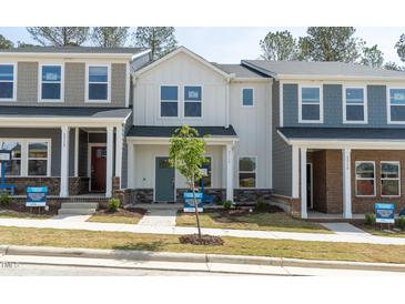 Charming exterior view of townhomes showcases unique architectural details and inviting entryways at 3717 Rosebush Dr, Zebulon, NC 27597