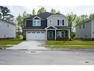 Beautiful two-story home with a two-car garage, neutral colors, and well-maintained lawn at 3829 Rosebush Dr, Zebulon, NC 27597