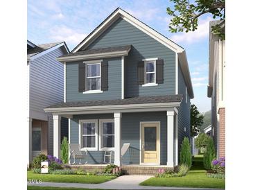 Charming two-story home features a covered front porch, beautiful landscaping, and a welcoming entryway at 934 Allen Park Dr, Knightdale, NC 27604