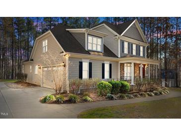 Charming home with a two-car garage and manicured landscaping at 1196 Smith Creek Way, Wake Forest, NC 27587